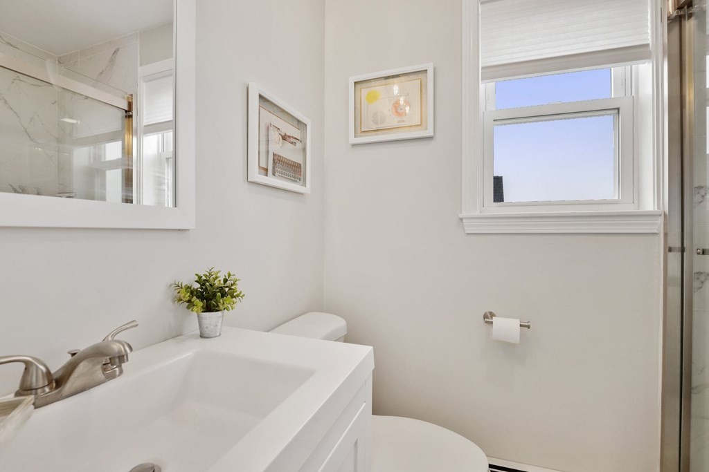 114 Waverly Street, Unit 3 Everett, MA 02149 - Photo 14 of 18 a bathroom with a sink mirror and toilet