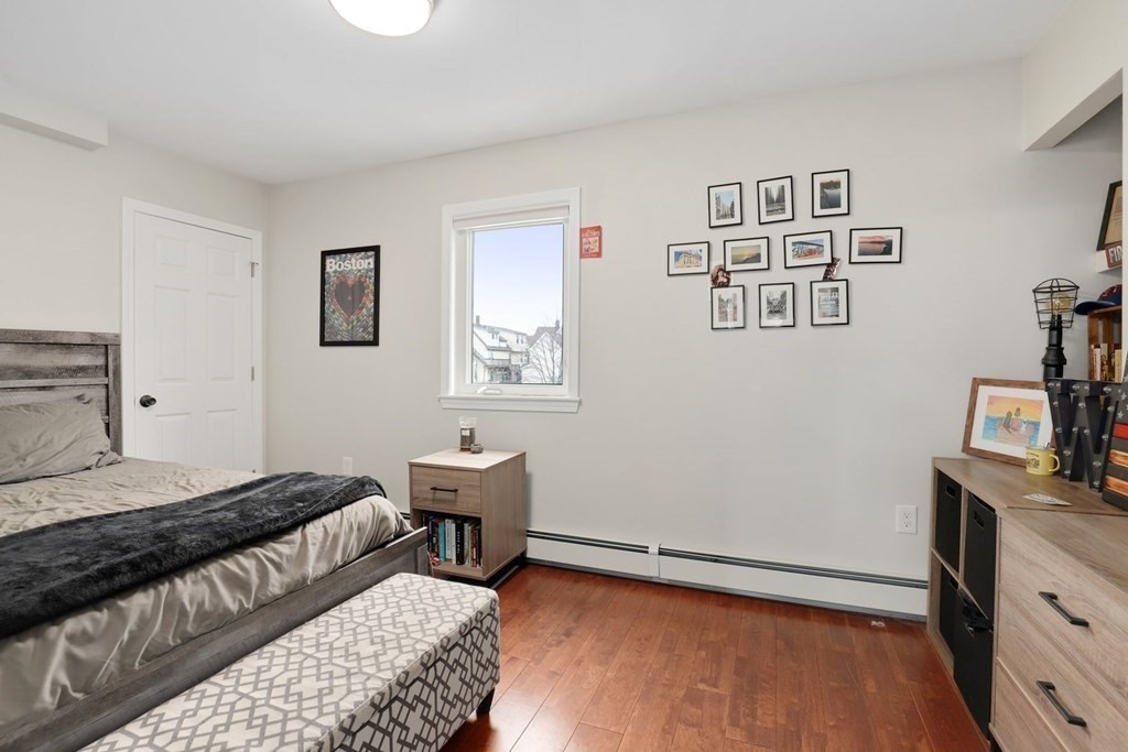 114 Waverly Street, Unit 3 Everett, MA 02149 - Photo 16 of 18 a bedroom with a bed and a desk