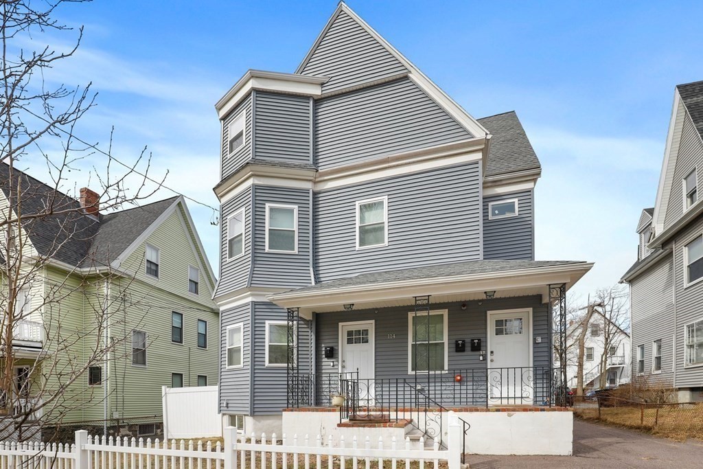 114 Waverly Street, Unit 3 Everett, MA 02149 - Photo 2 of 18 a view of a white house with large windows