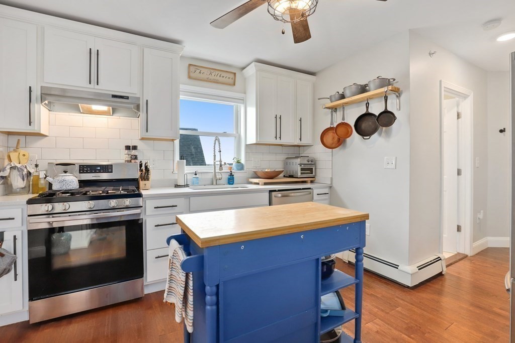 114 Waverly Street, Unit 3 Everett, MA 02149 - Photo 3 of 18 a kitchen with a stove and a refrigerator
