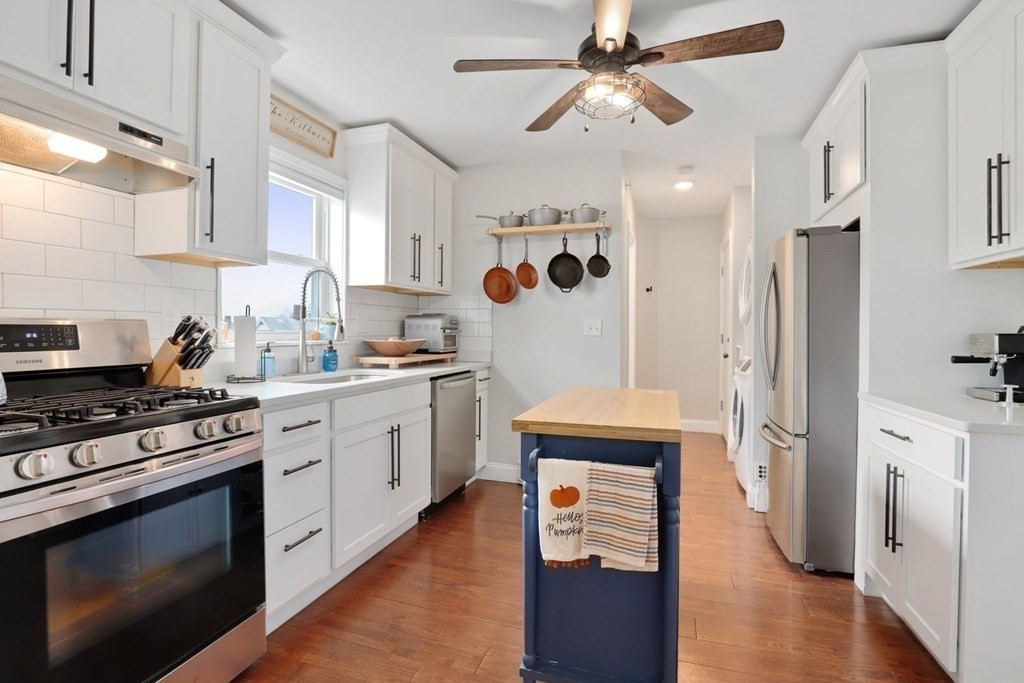 114 Waverly Street, Unit 3 Everett, MA 02149 - Photo 4 of 18 a kitchen with stainless steel appliances a stove a sink and a refrigerator