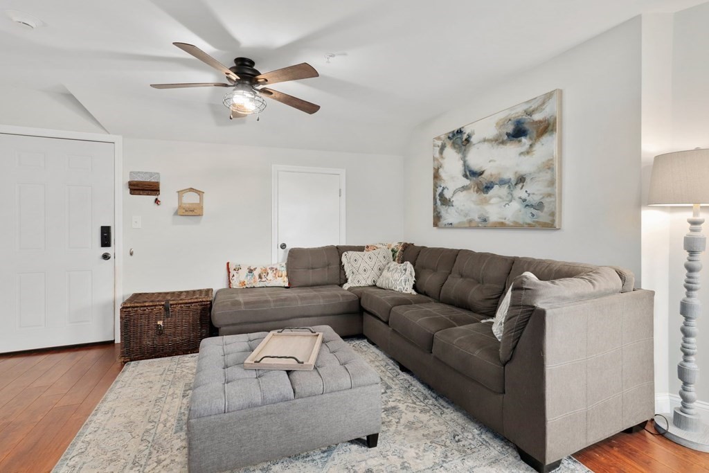 114 Waverly Street, Unit 3 Everett, MA 02149 - Photo 8 of 18 a living room with furniture and a chandelier