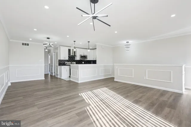 a view of wooden floor and a kitchen