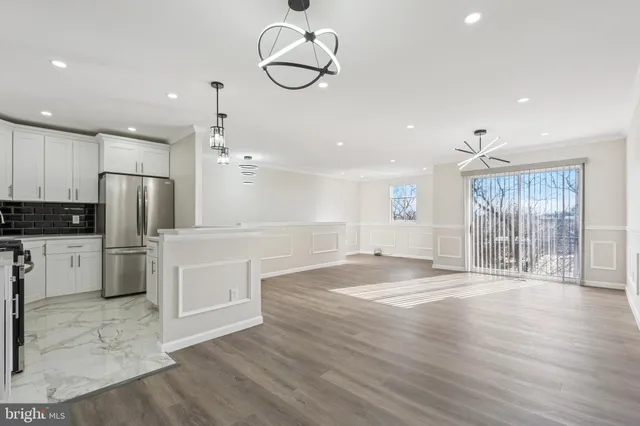 a view of a kitchen with a sink stainless steel appliances and cabinets