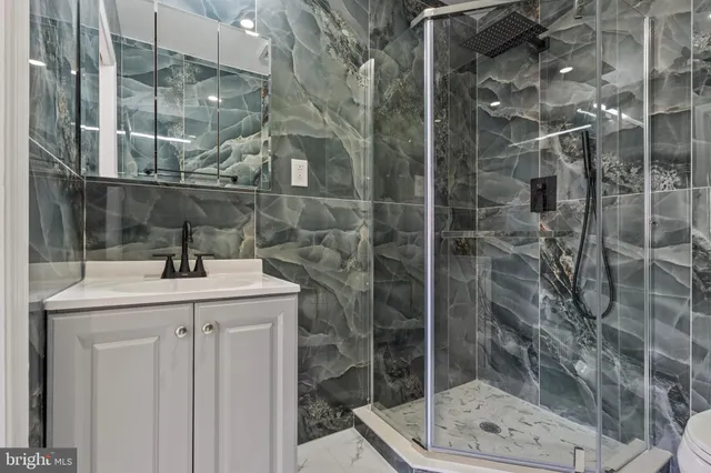 a bathroom with a shower and sink