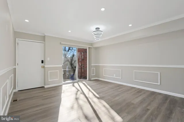 a view of empty room with wooden floor