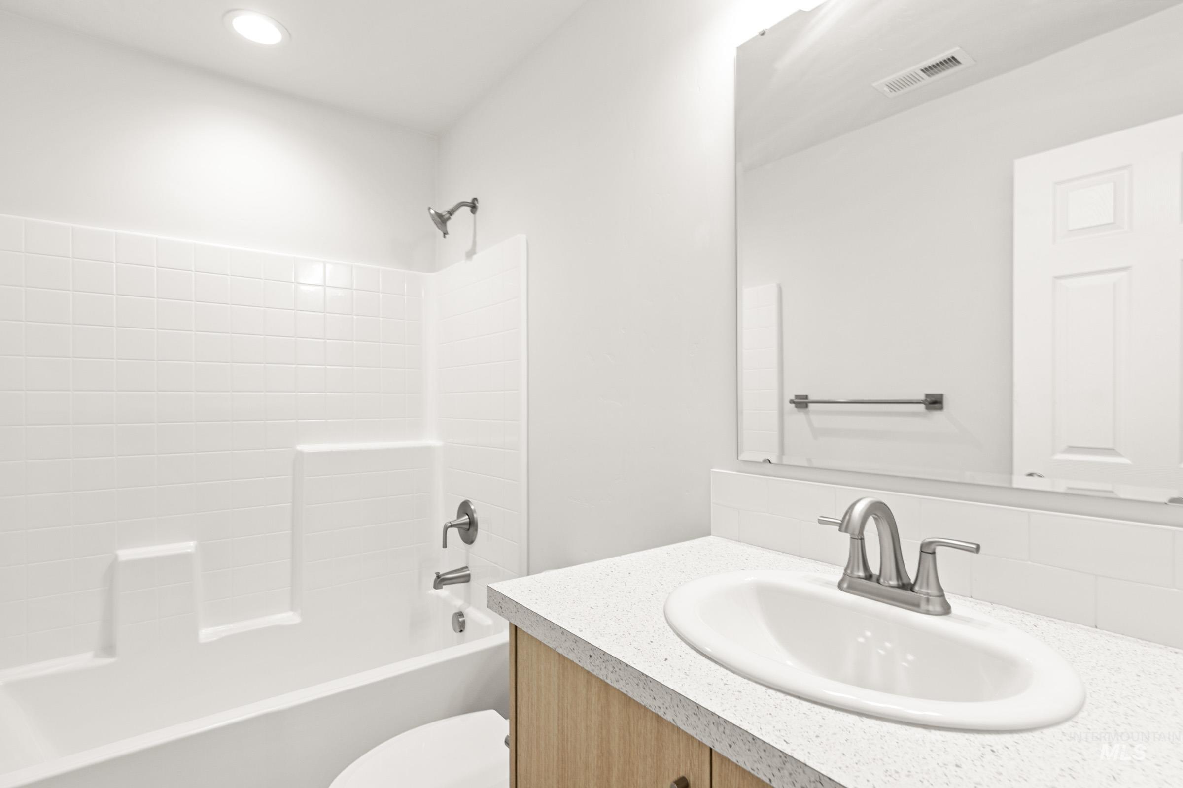 13736 Inman Court Caldwell, ID 83607 - Photo 11 of 20 Bathroom featuring vanity and shower / washtub combination
