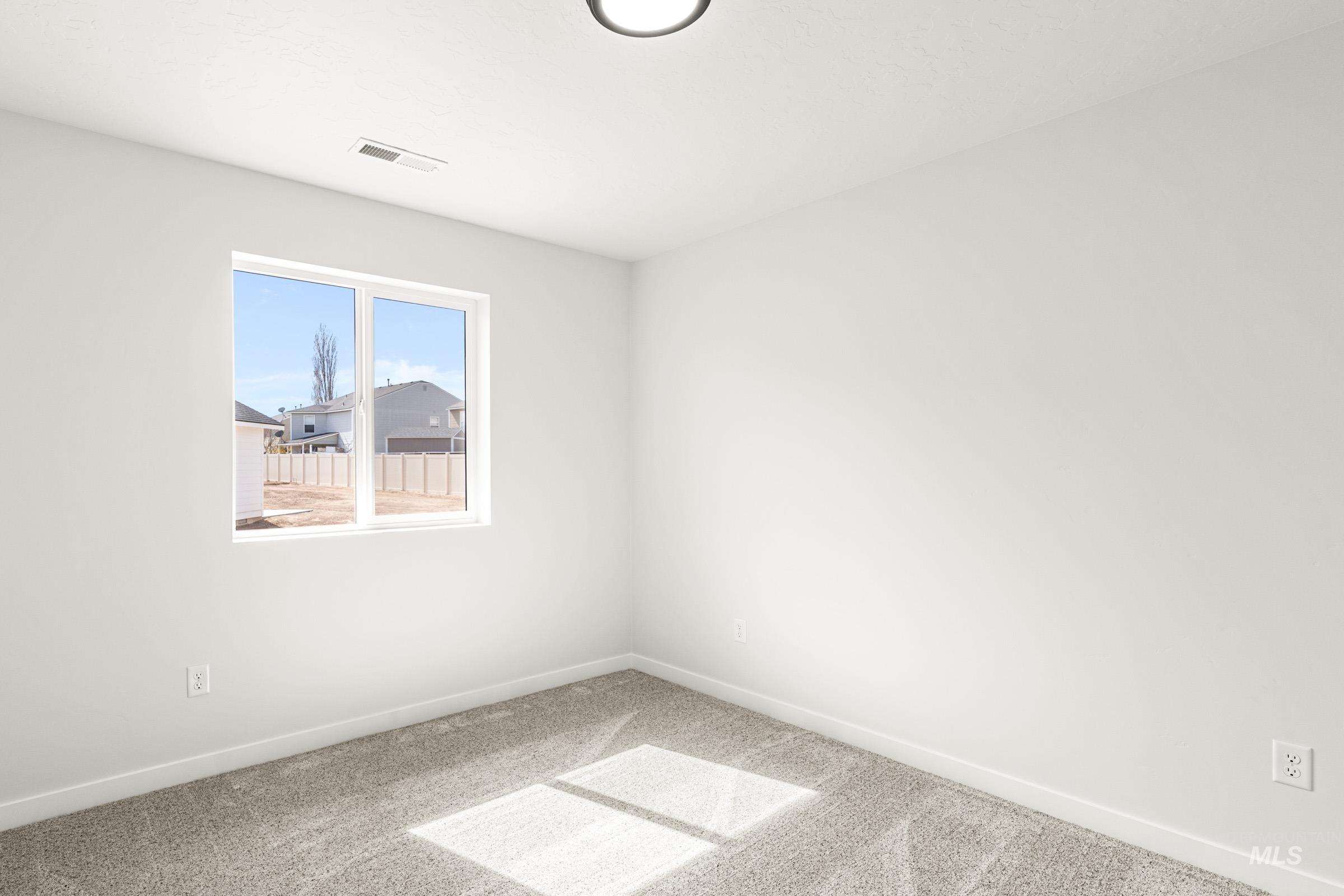 13736 Inman Court Caldwell, ID 83607 - Photo 12 of 20 Unfurnished room featuring baseboards and light carpet