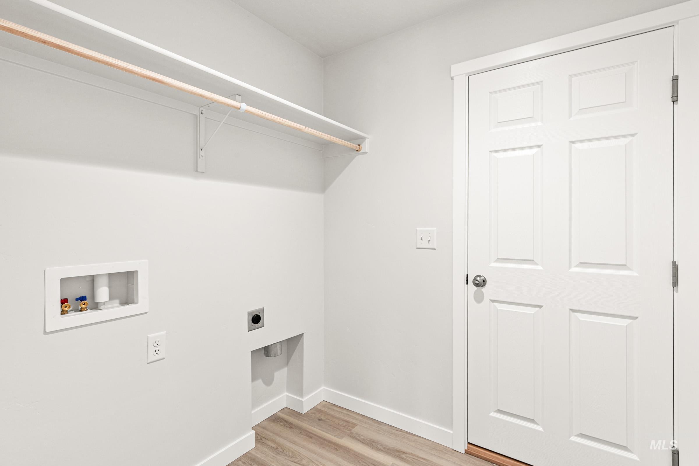 13736 Inman Court Caldwell, ID 83607 - Photo 13 of 20 Laundry area with hookup for an electric dryer, light wood-style floors, and hookup for a washing machine