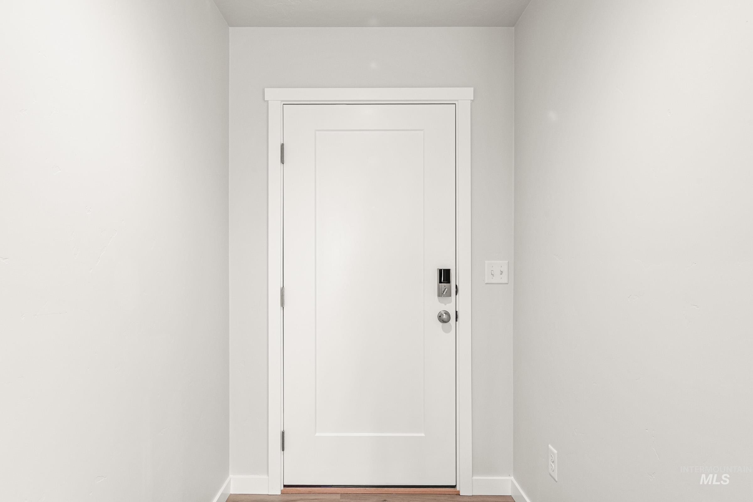 13736 Inman Court Caldwell, ID 83607 - Photo 2 of 20 Doorway with baseboards and wood finished floors
