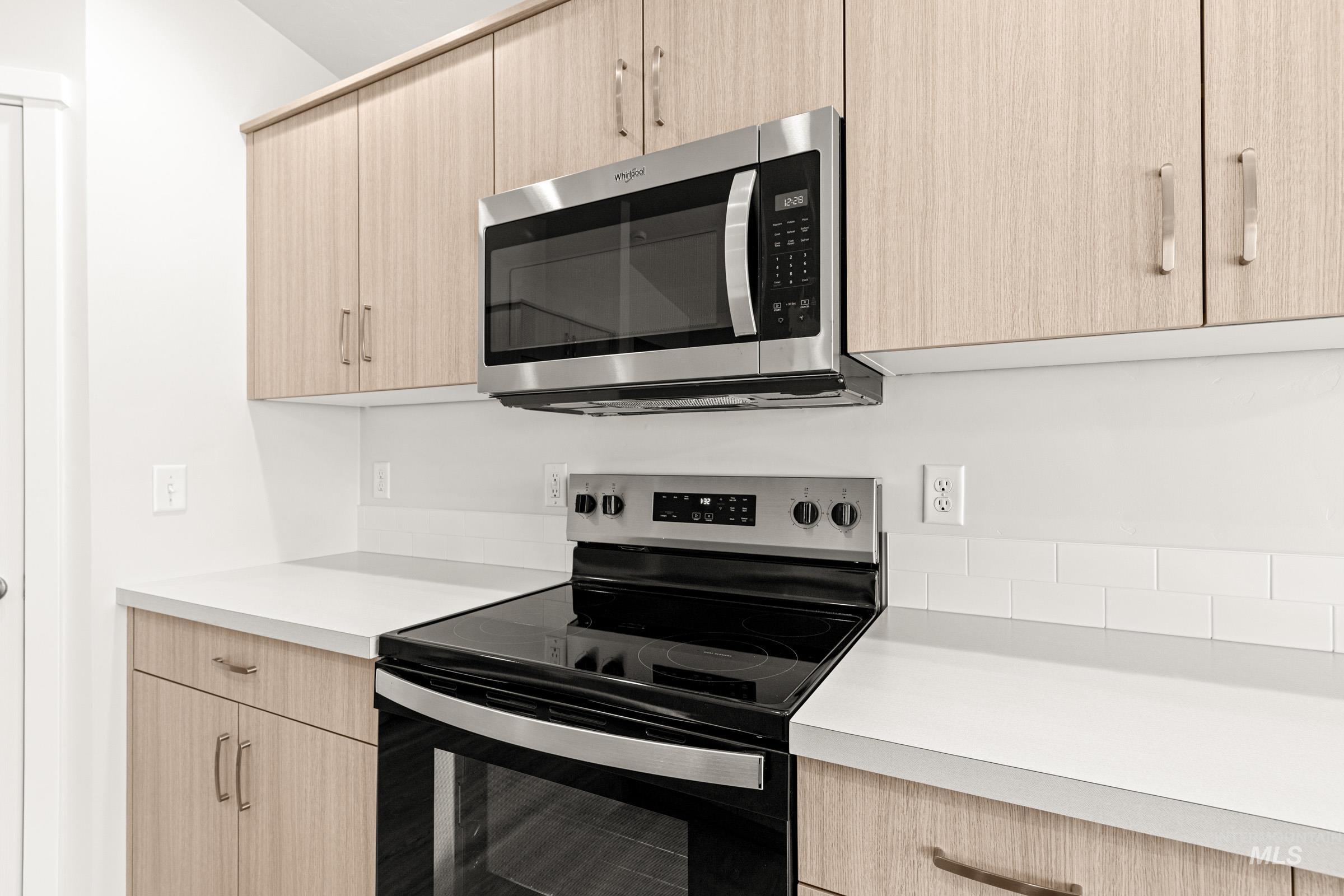 13736 Inman Court Caldwell, ID 83607 - Photo 8 of 20 Kitchen with light wood finish cabinets, stainless steel appliances, light countertops, and modern cabinets