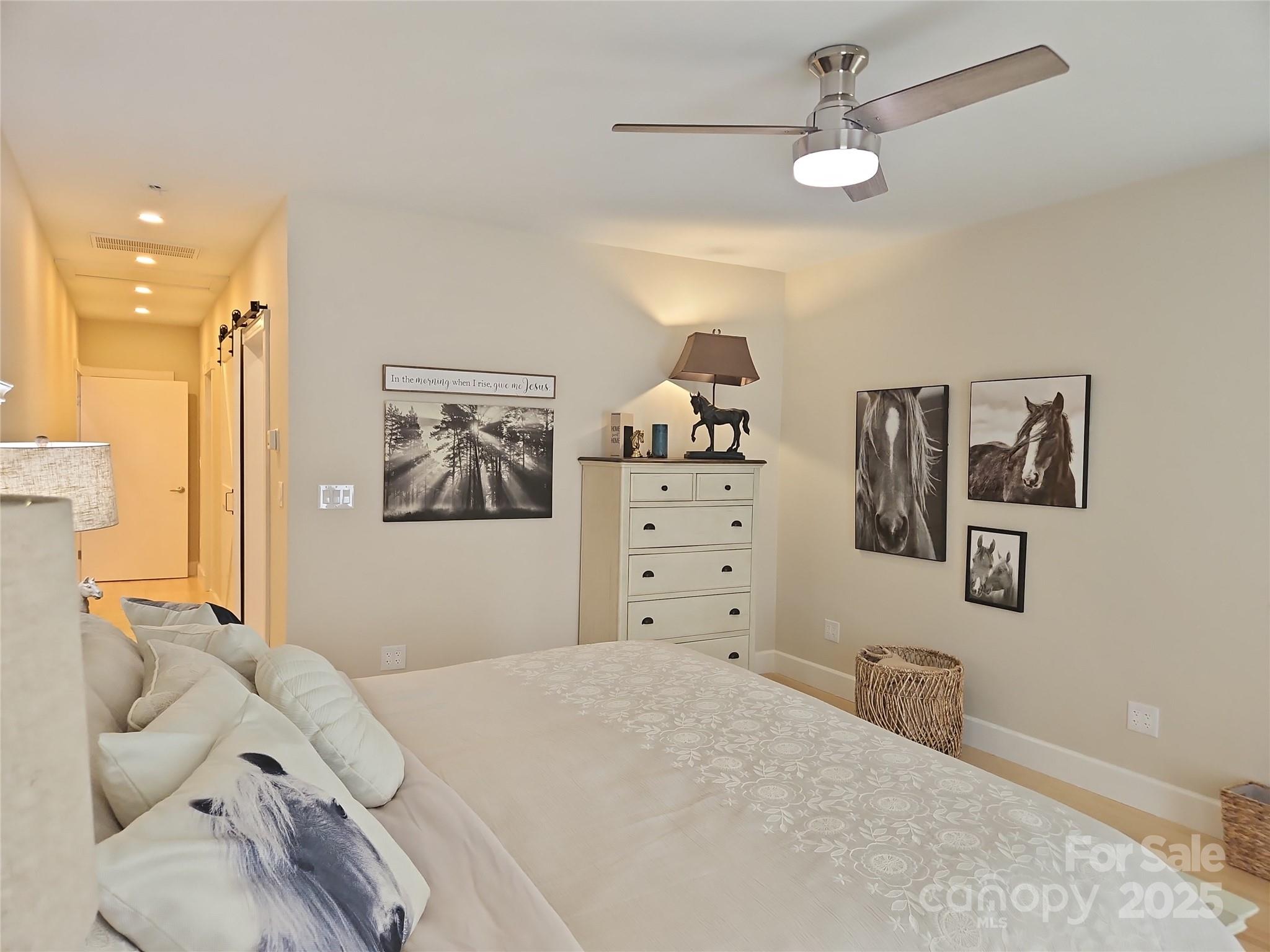 2905 Medlin Road Monroe, NC 28112 - Photo 14 of 39 a bedroom with a bed and a chandelier