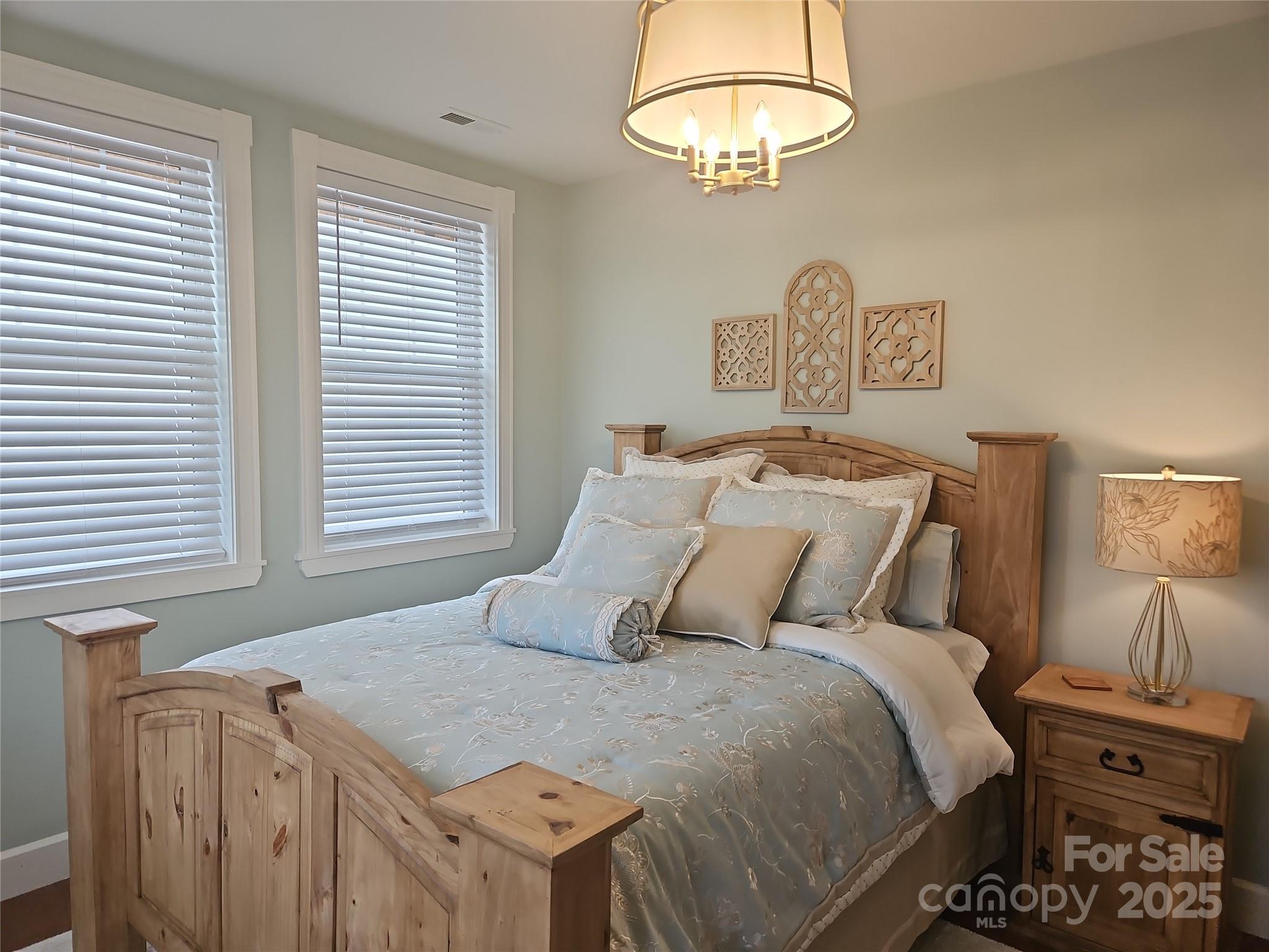 2905 Medlin Road Monroe, NC 28112 - Photo 18 of 39 a bedroom with a bed and a chandelier