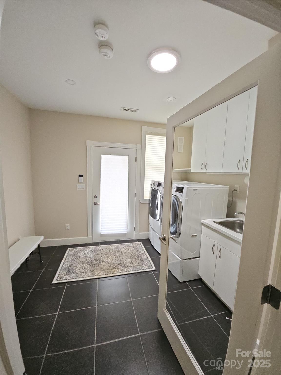 2905 Medlin Road Monroe, NC 28112 - Photo 26 of 39 a kitchen with a sink a stove and cabinets