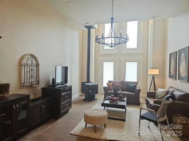 a living room with furniture chandelier and a view of kitchen