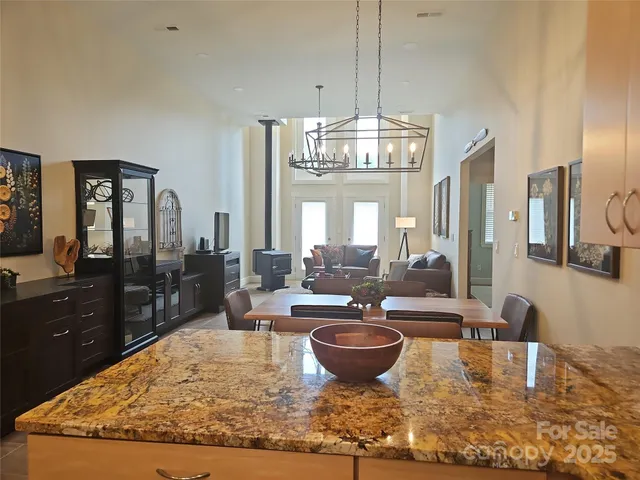 a view of a dining room with furniture a chandelier and wooden floor