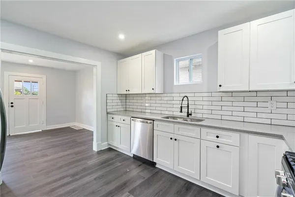 a kitchen with stainless steel appliances granite countertop a refrigerator and a stove top oven