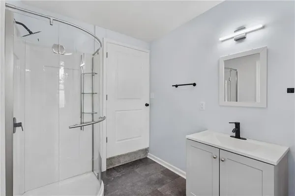 a bedroom with a large bed and a window