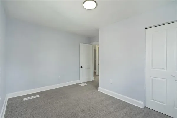 a bedroom with a large bed and a potted plant