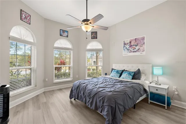 a bedroom with a large bed and a chandelier