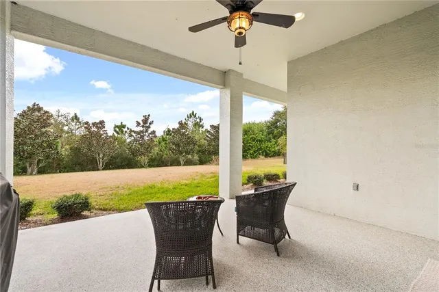 a view of an outdoor dining space with furniture and garden