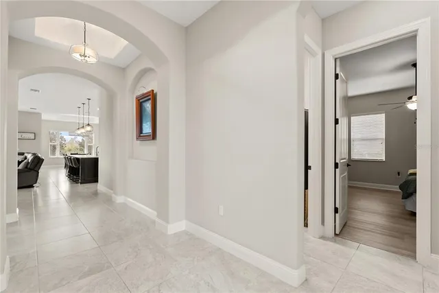 a view of a hallway with furniture and a livingroom view