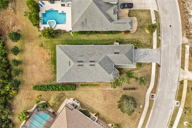 an aerial view of a house with a yard
