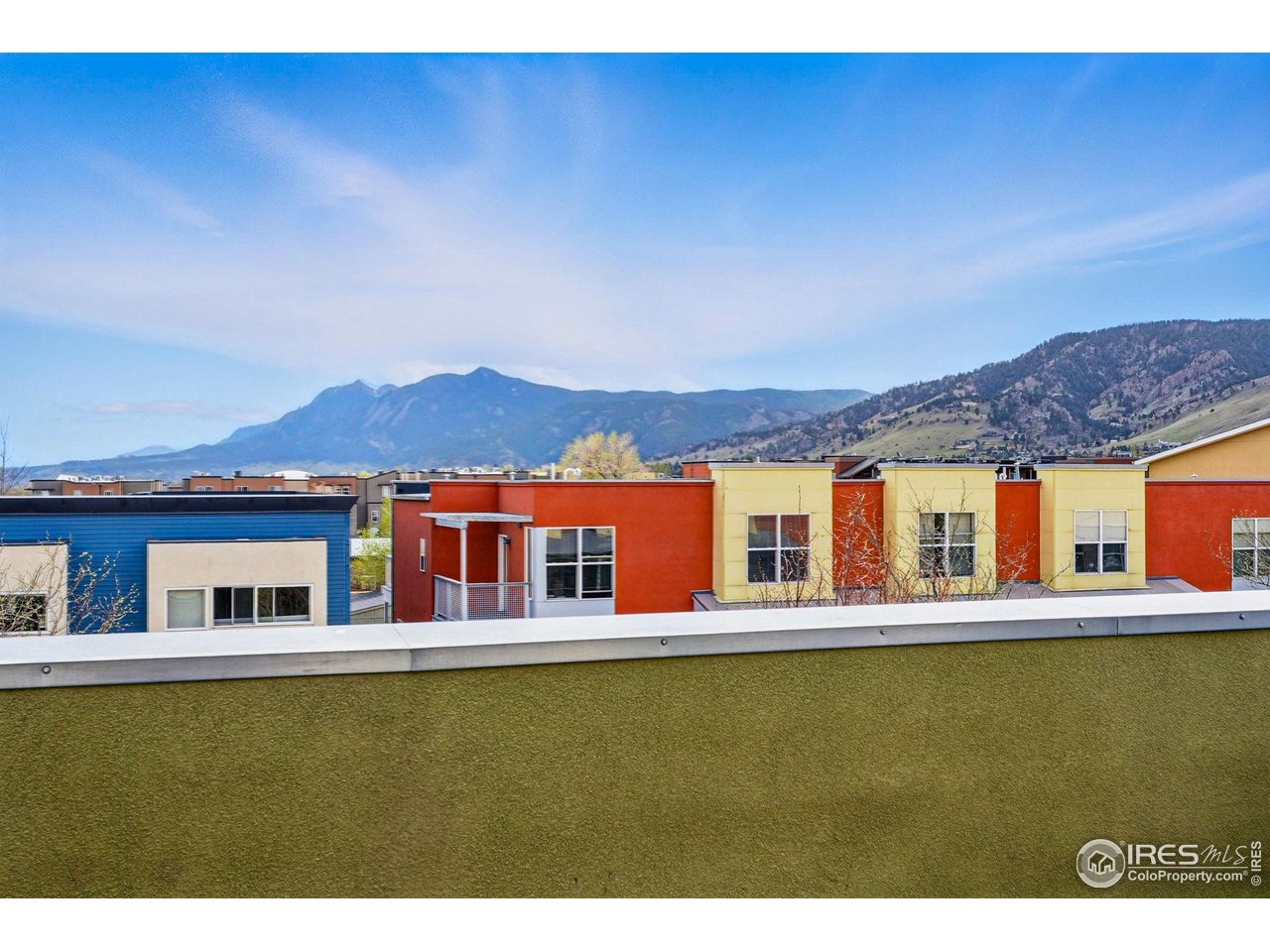 a view of a large building with a big yard and large trees