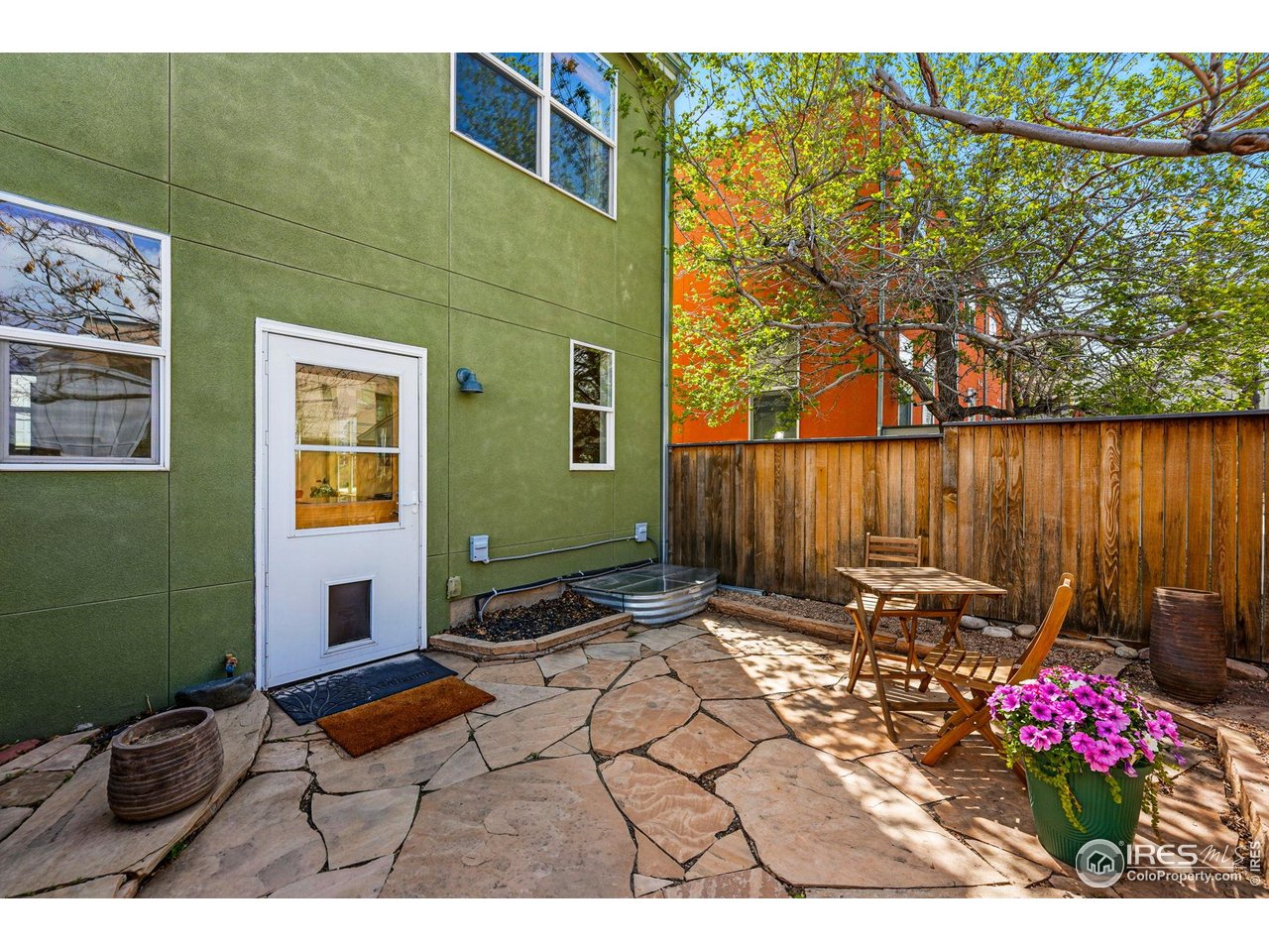 1351 Yellow Pine Avenue Boulder, CO 80304 - Photo 4 of 34 a backyard of a house with table and chairs