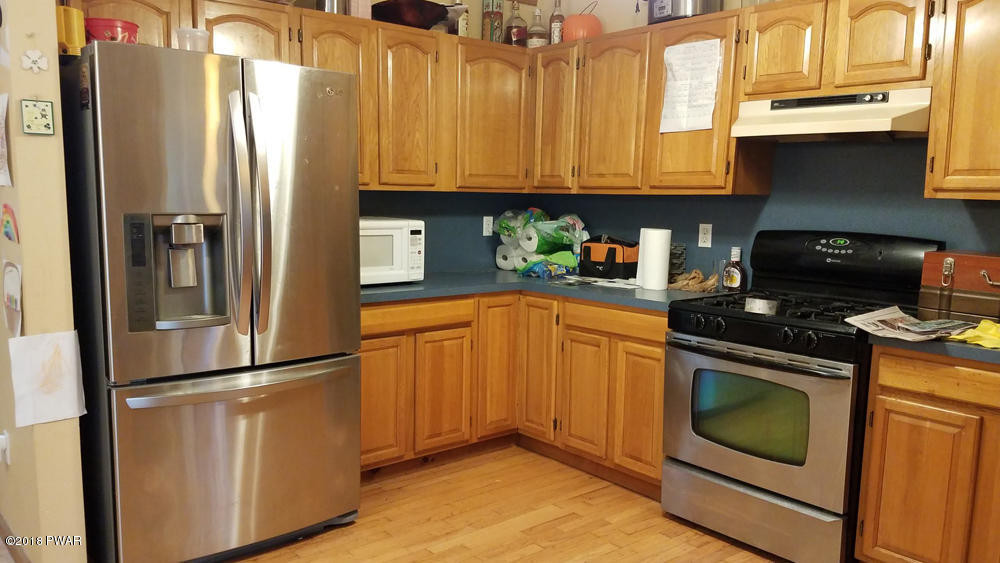 185 Fox Road Dingmans Ferry, PA 18328 - Photo 4 of 19 a kitchen with stainless steel appliances granite countertop a refrigerator a stove and a sink