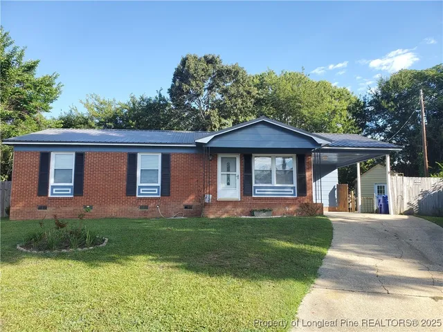 a front view of a house with a yard and porch