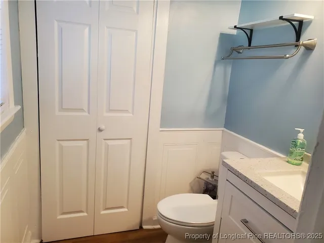 a white toilet sitting next to a bathroom sink