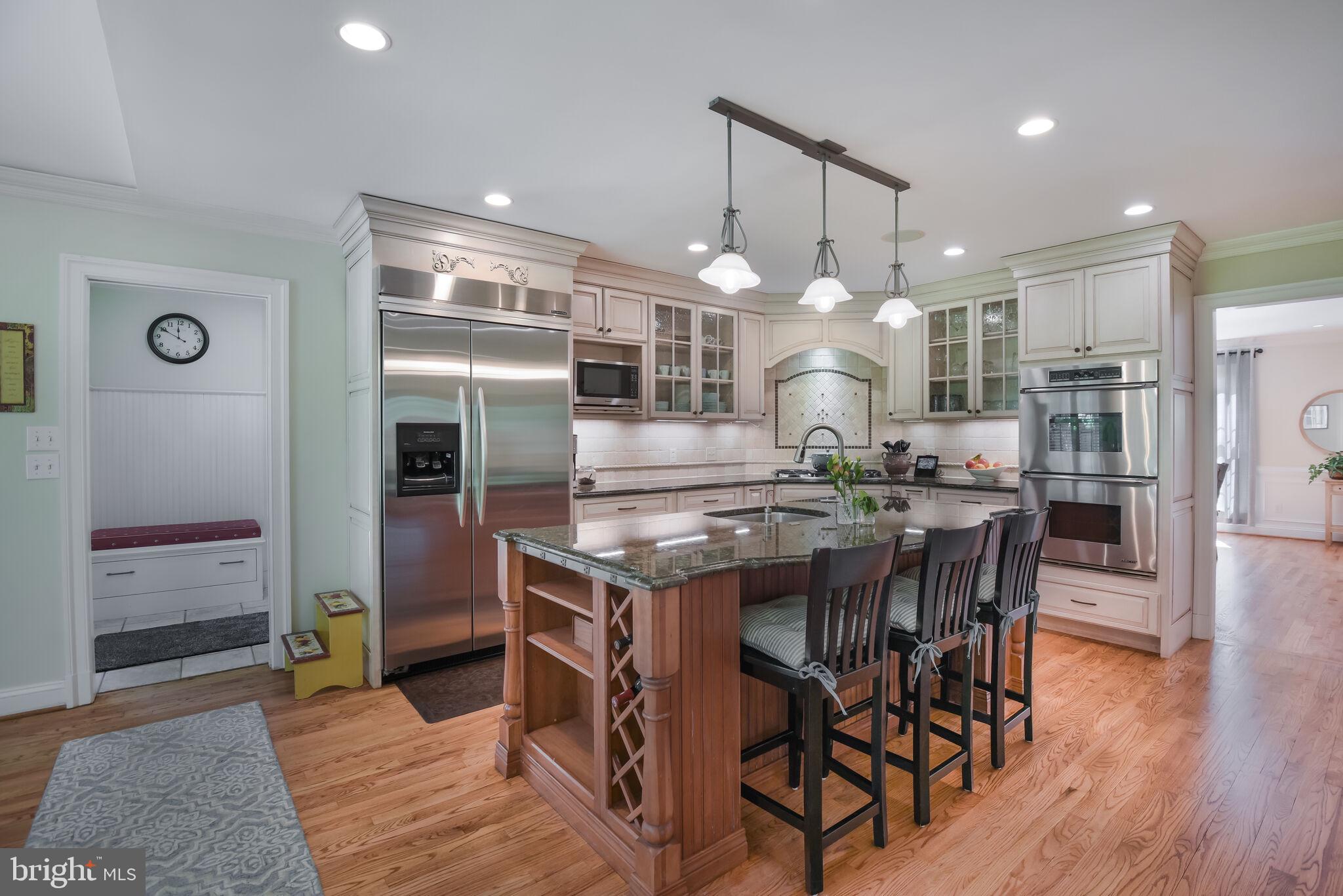 10601 Gainsborough Road Potomac, MD 20854 - Photo 18 of 55 a kitchen with stainless steel appliances granite countertop a stove and a refrigerator