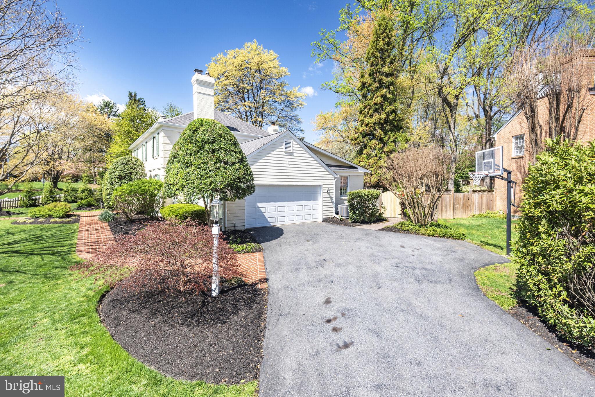10601 Gainsborough Road Potomac, MD 20854 - Photo 2 of 55 a front view of a house with garden