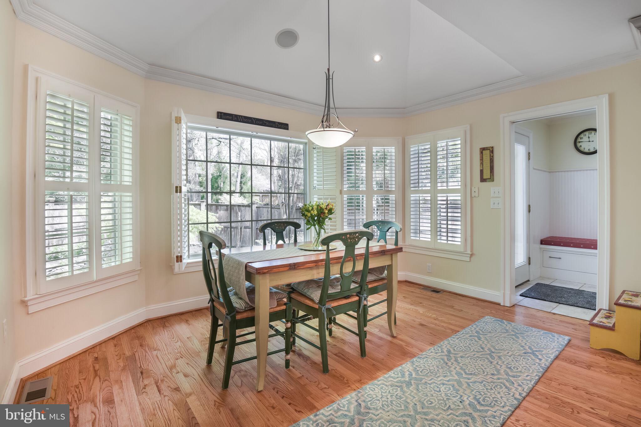 10601 Gainsborough Road Potomac, MD 20854 - Photo 22 of 55 a dining room with furniture a chandelier and wooden floor