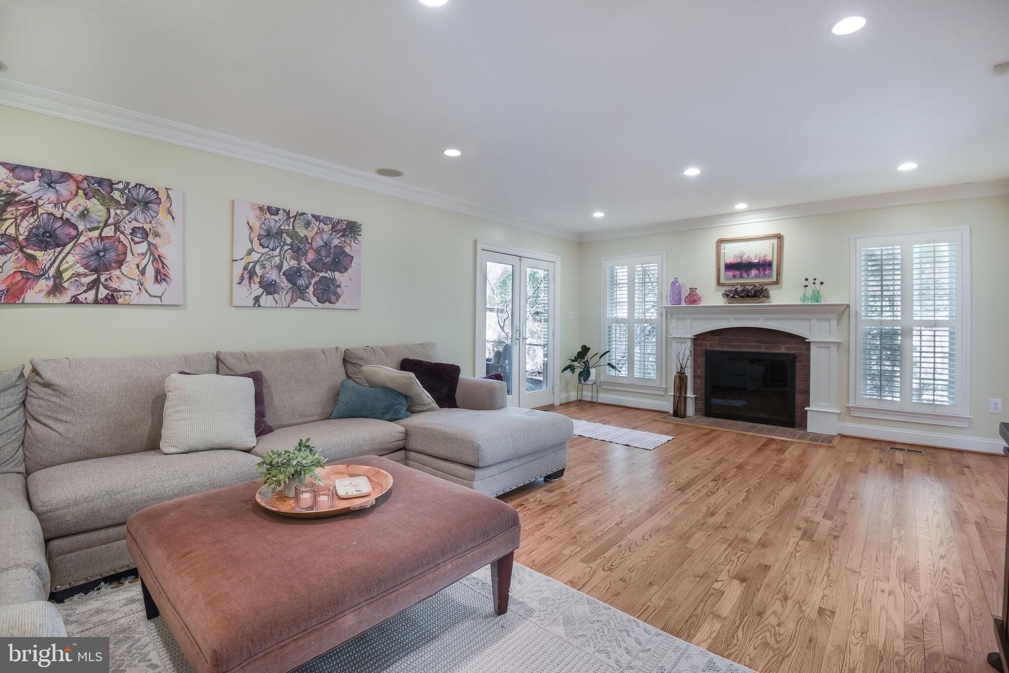 10601 Gainsborough Road Potomac, MD 20854 - Photo 26 of 55 a living room with furniture a fireplace and a flat screen tv