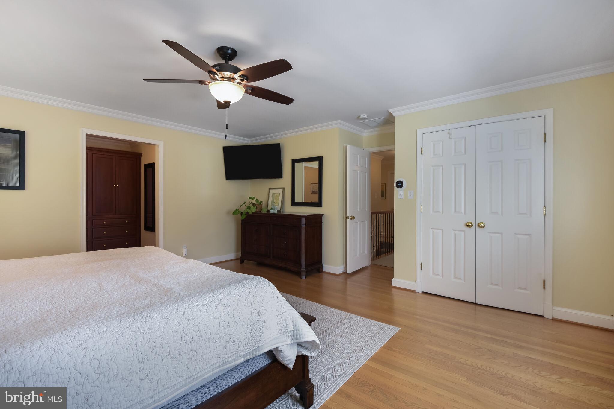 10601 Gainsborough Road Potomac, MD 20854 - Photo 32 of 55 a bedroom with a bed and a chandelier