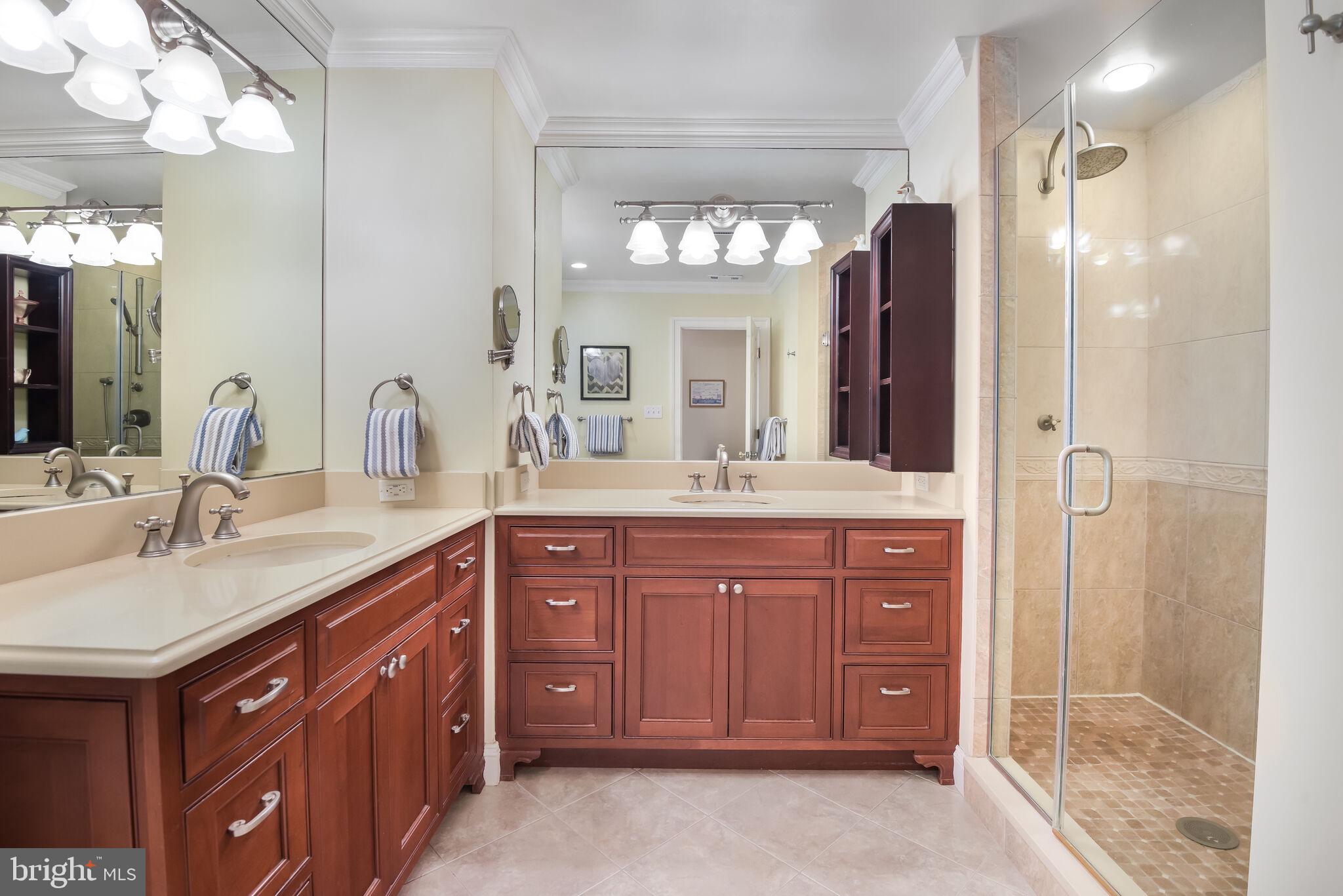 10601 Gainsborough Road Potomac, MD 20854 - Photo 34 of 55 a bathroom with a granite countertop sink a mirror and a shower