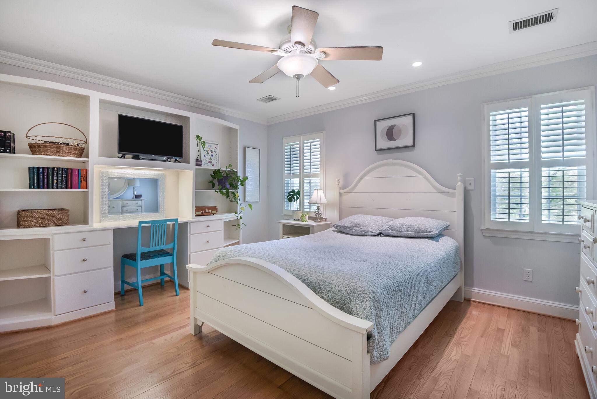 10601 Gainsborough Road Potomac, MD 20854 - Photo 36 of 55 a bedroom with a large bed and a flat tv screen on dresser