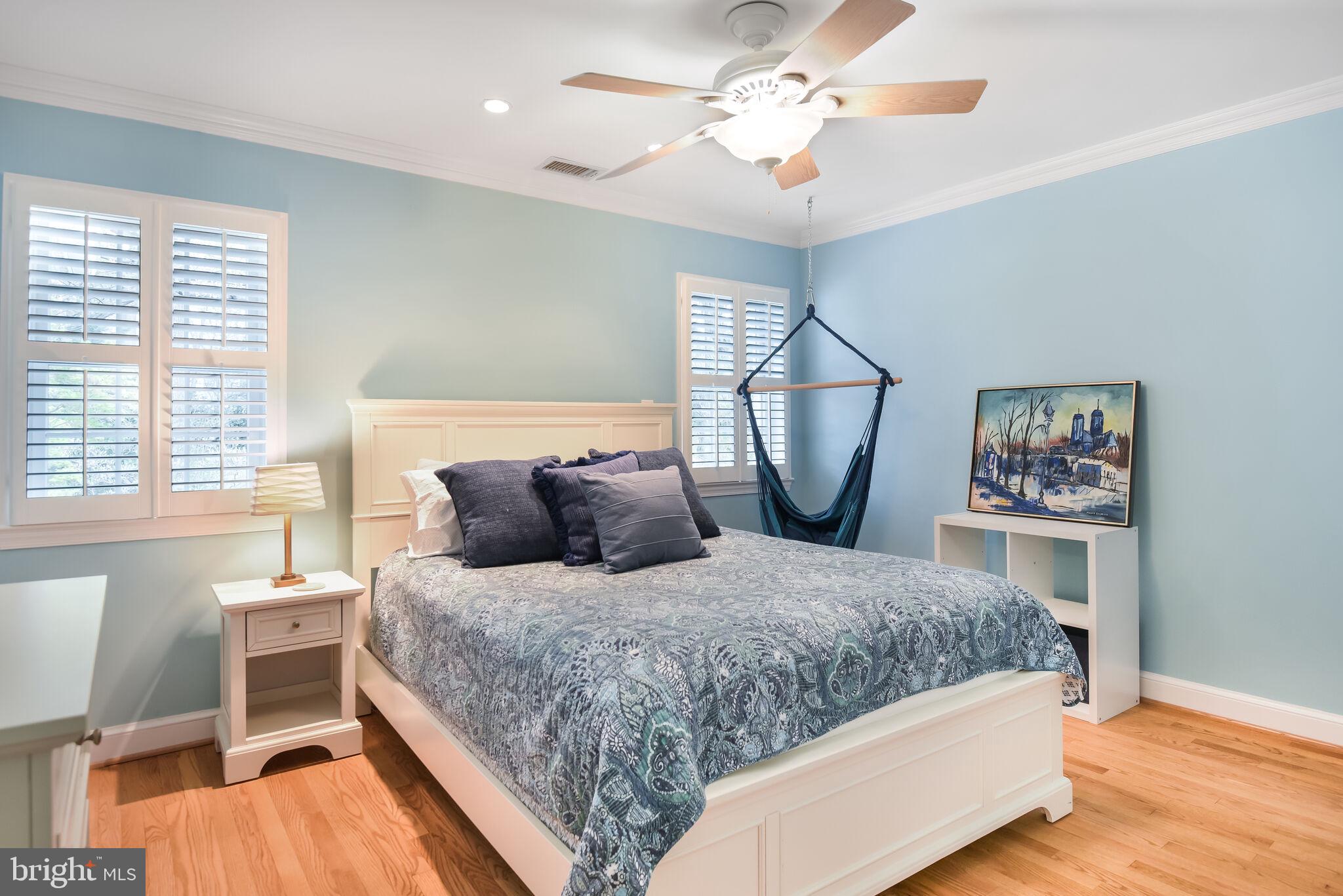 10601 Gainsborough Road Potomac, MD 20854 - Photo 38 of 55 a bedroom with a large bed and a chandelier