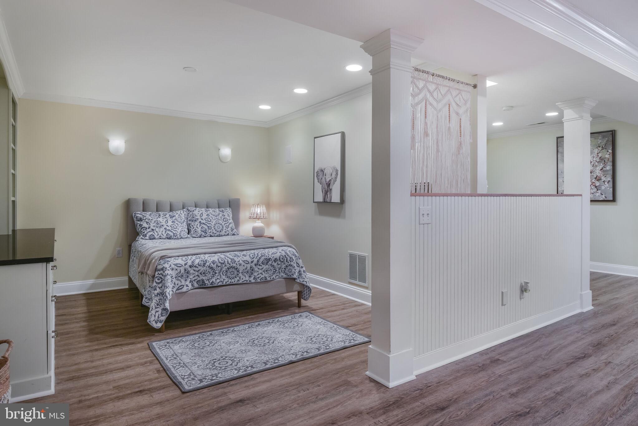 10601 Gainsborough Road Potomac, MD 20854 - Photo 42 of 55 a bedroom with a large bed and wooden floor