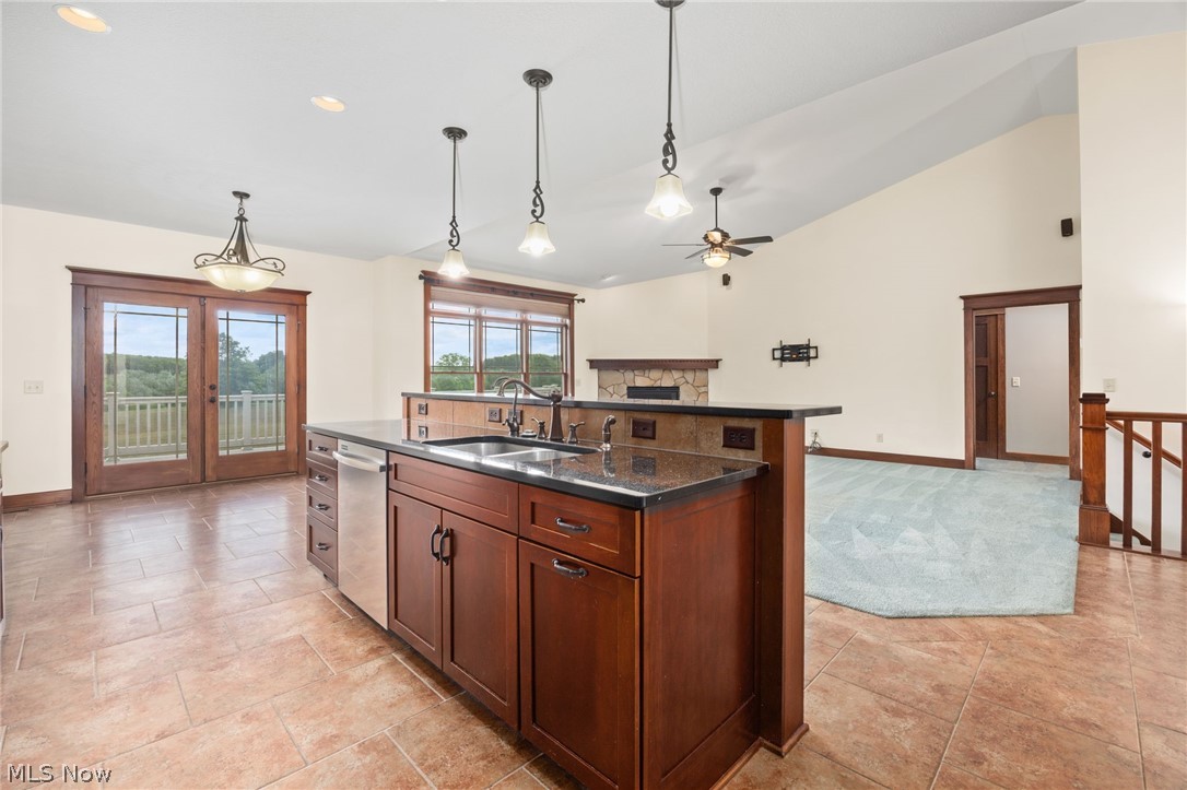 6925 River Styx Road Medina, OH 44256 - Photo 12 of 49 Gourmet kitchen island with dark wood cabinetry, granite countertop, and stainless steel sink