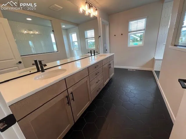 a spacious bathroom with a double vanity sink and a mirror