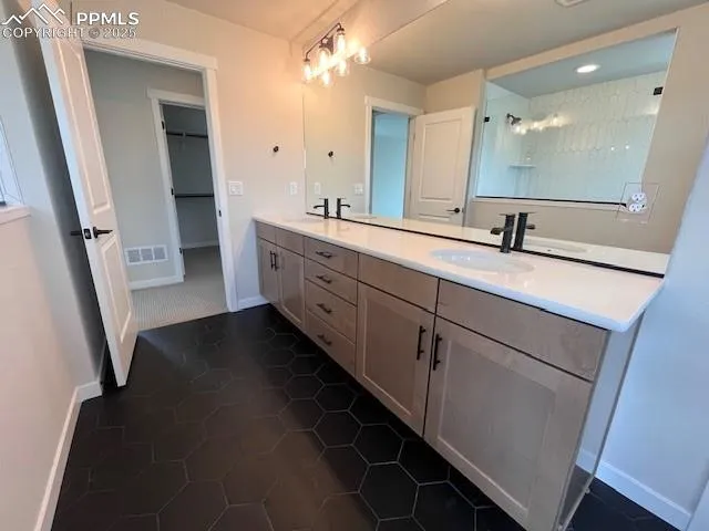 a bathroom with a double vanity sink and mirror