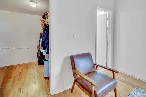 a view of a hallway with wooden floor and stairs