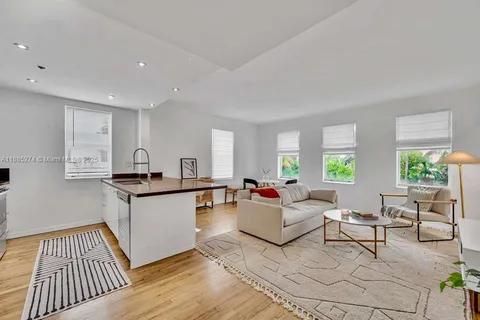 a living room with kitchen island furniture and a wooden floor