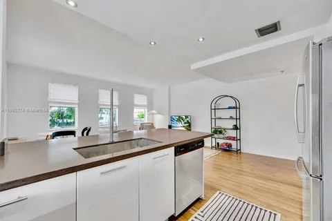a very nice looking living room with a large window and potted plants