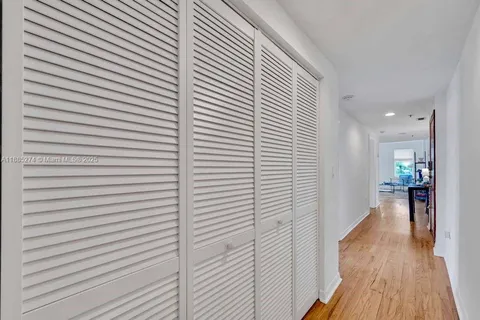 a view of a room with wooden floor