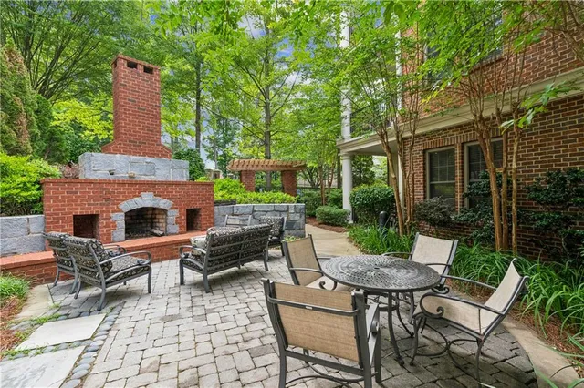 a view of a patio with a dining table and chairs with wooden fence