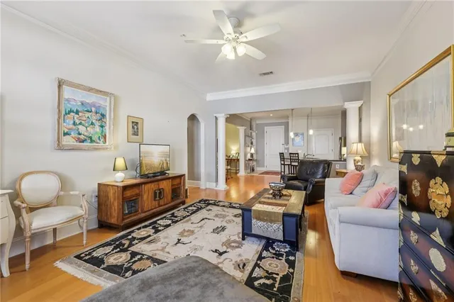 a living room with furniture a rug and a chandelier